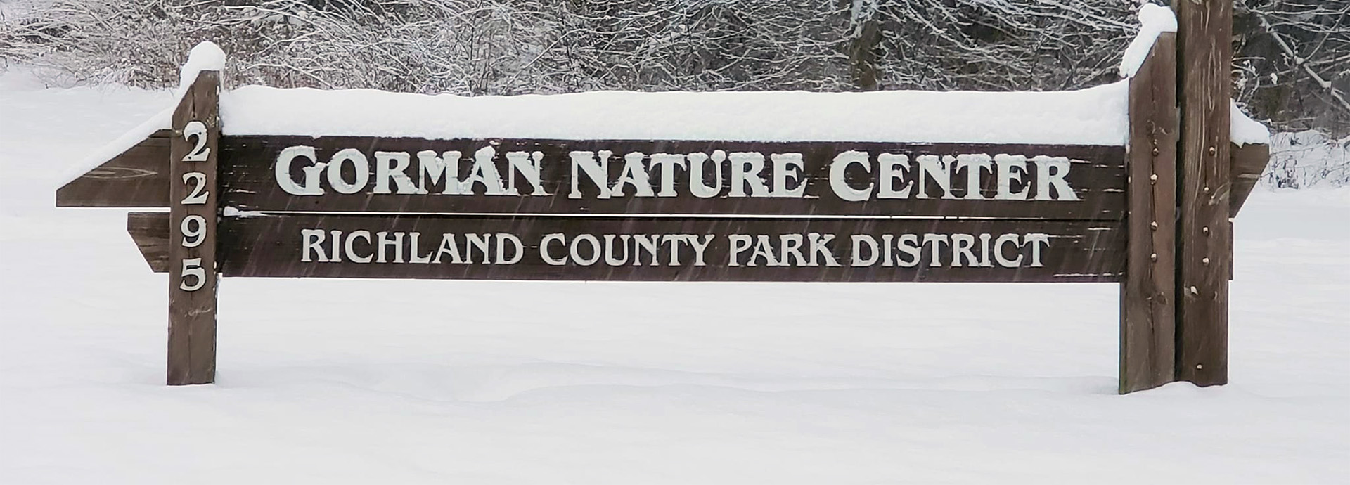 Slideshow Image - Closeup of the GNC welcome sign, coated in a neat layer of snow