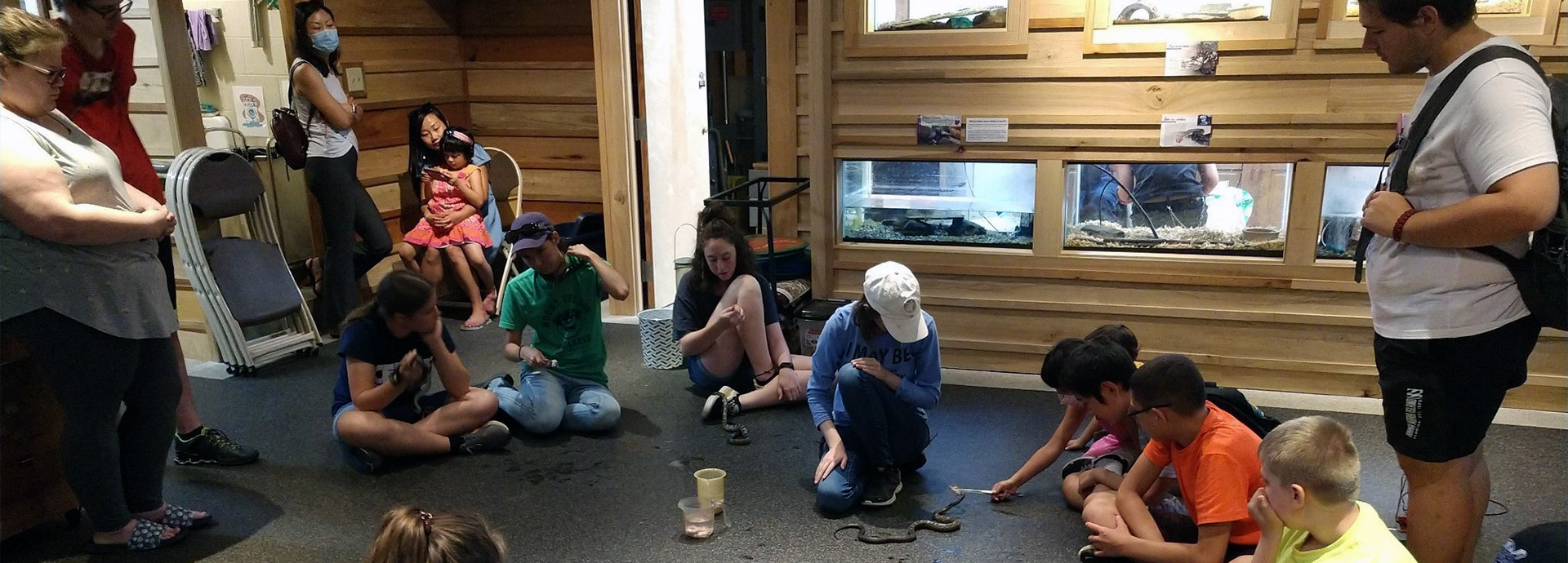 Slideshow Image - Staff and volunteers feeding the nature center animals