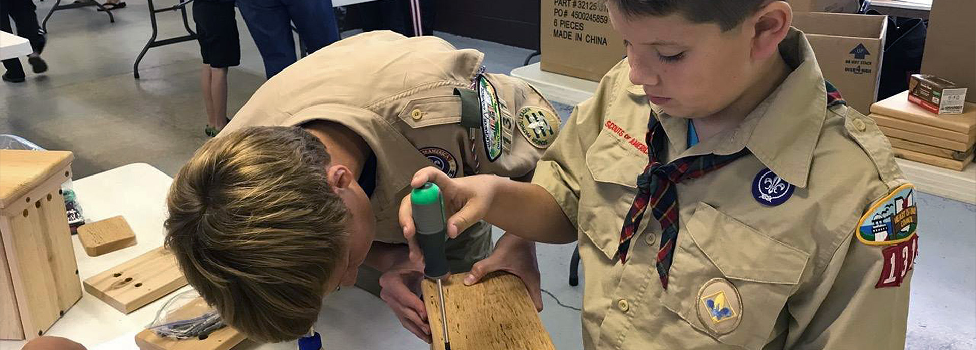 Slideshow Image - Two boy scouts building bluebird nest boxes